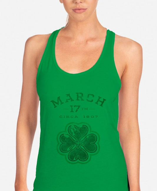 a woman wearing a green tank top with a shamrock on it